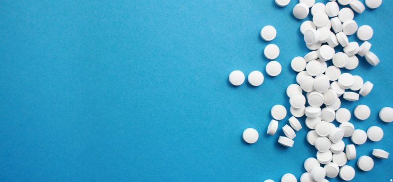 White circular pills on a blue background.