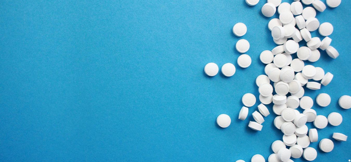 White circular pills on a blue background.